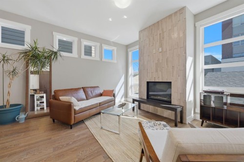 2-4620 17 Avenue Nw, Calgary, AB - Indoor Photo Showing Living Room With Fireplace