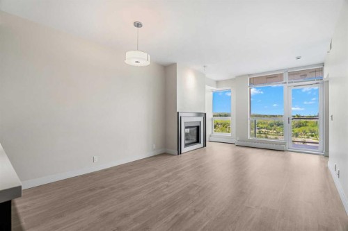 1712-222 Riverfront Avenue Sw, Calgary, AB - Indoor Photo Showing Living Room With Fireplace