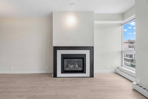 1712-222 Riverfront Avenue Sw, Calgary, AB - Indoor Photo Showing Living Room With Fireplace