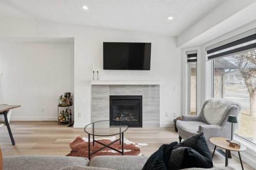 194 Martinglen Way Ne, Calgary, AB - Indoor Photo Showing Living Room With Fireplace