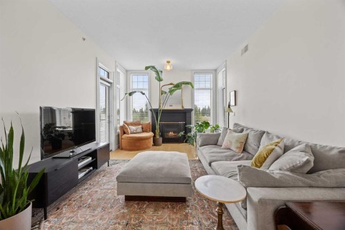 301-2121 98 Avenue Sw, Calgary, AB - Indoor Photo Showing Living Room With Fireplace