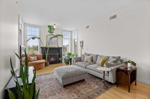 301-2121 98 Avenue Sw, Calgary, AB - Indoor Photo Showing Living Room With Fireplace