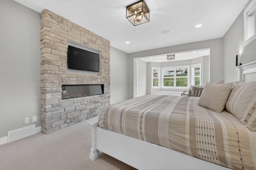 125 Hampstead Mews Nw, Calgary, AB - Indoor Photo Showing Bedroom With Fireplace
