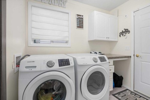 704 Woodside Drive Nw, Airdrie, AB - Indoor Photo Showing Laundry Room