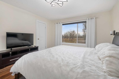 704 Woodside Drive Nw, Airdrie, AB - Indoor Photo Showing Bedroom