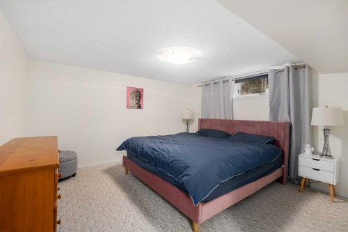 704 Woodside Drive Nw, Airdrie, AB - Indoor Photo Showing Bedroom