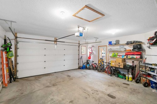 704 Woodside Drive Nw, Airdrie, AB - Indoor Photo Showing Garage