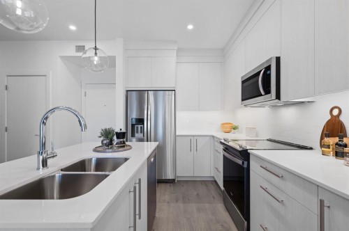 4313-6 Merganser Drive West, Chestermere, AB - Indoor Photo Showing Kitchen With Double Sink With Upgraded Kitchen