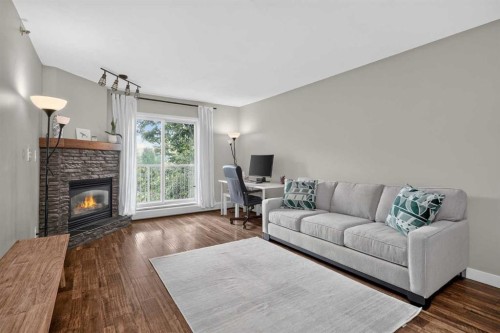 308-1415 17 Street, Calgary, AB - Indoor Photo Showing Living Room With Fireplace