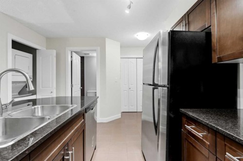215-7110 80 Avenue Ne, Calgary, AB - Indoor Photo Showing Kitchen With Double Sink