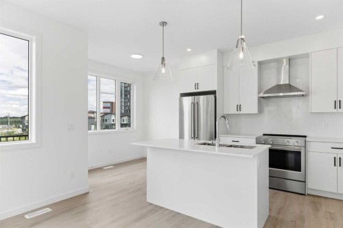 11-1453 Na'A Drive Sw, Calgary, AB - Indoor Photo Showing Kitchen With Stainless Steel Kitchen With Upgraded Kitchen