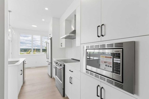 11-1453 Na'A Drive Sw, Calgary, AB - Indoor Photo Showing Kitchen With Stainless Steel Kitchen With Upgraded Kitchen