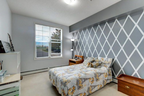 123-1 Crystal Green, Okotoks, AB - Indoor Photo Showing Bedroom