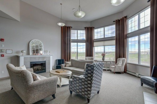 123-1 Crystal Green, Okotoks, AB - Indoor Photo Showing Living Room With Fireplace