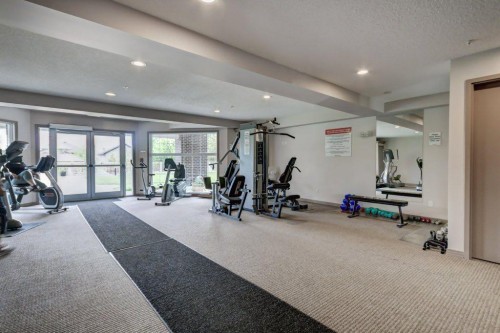 123-1 Crystal Green, Okotoks, AB - Indoor Photo Showing Gym Room