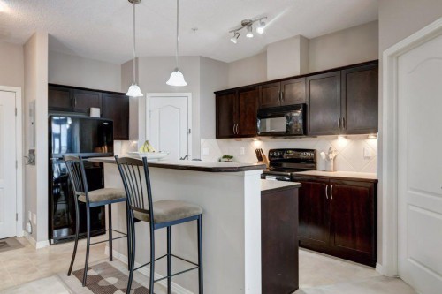 123-1 Crystal Green, Okotoks, AB - Indoor Photo Showing Kitchen