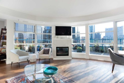 1005-205 Riverfront Avenue Sw, Calgary, AB - Indoor Photo Showing Living Room With Fireplace