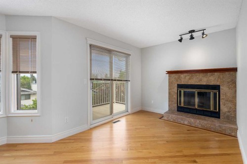 112 Hawkford Crescent Nw, Calgary, AB - Indoor Photo Showing Living Room With Fireplace