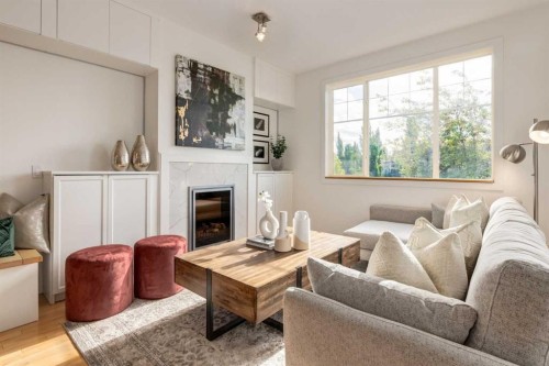 804-281 Cougar Ridge Drive Sw, Calgary, AB - Indoor Photo Showing Living Room With Fireplace