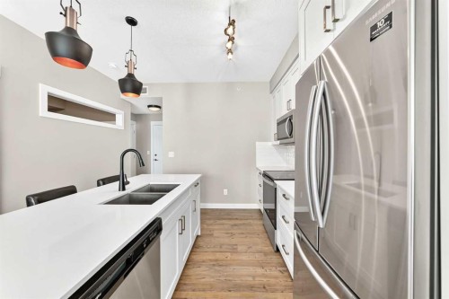 402-300 Auburn Meadows Common Se, Calgary, AB - Indoor Photo Showing Kitchen With Stainless Steel Kitchen With Double Sink With Upgraded Kitchen