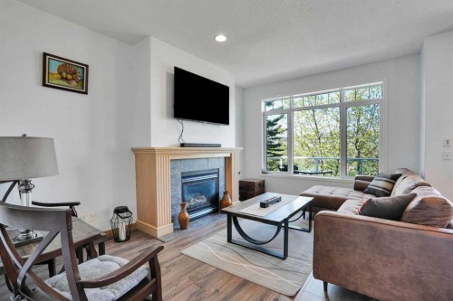 6 Discovery Woods Villas Sw, Calgary, AB - Indoor Photo Showing Living Room With Fireplace