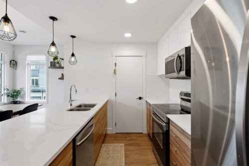 603-10060 46 Street Ne, Calgary, AB - Indoor Photo Showing Kitchen With Stainless Steel Kitchen With Double Sink With Upgraded Kitchen