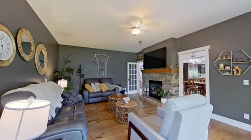 24-33049 Range Road 12, Rural Mountain View County, AB - Indoor Photo Showing Living Room With Fireplace