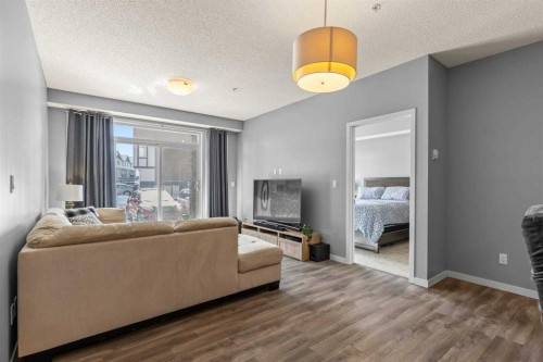 114-6703 New Brighton Avenue Se, Calgary, AB - Indoor Photo Showing Living Room With Fireplace