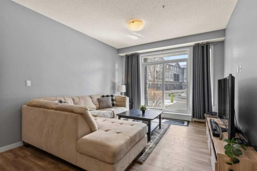 114-6703 New Brighton Avenue Se, Calgary, AB - Indoor Photo Showing Living Room