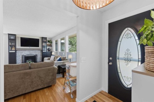 331 Queensland Circle Se, Calgary, AB - Indoor Photo Showing Living Room With Fireplace