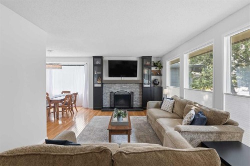 331 Queensland Circle Se, Calgary, AB - Indoor Photo Showing Living Room With Fireplace