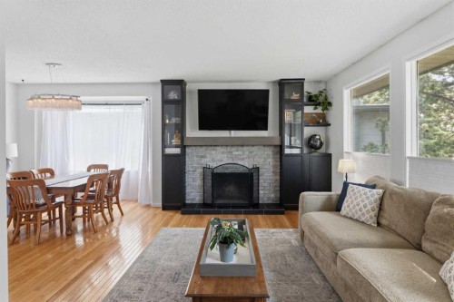 331 Queensland Circle Se, Calgary, AB - Indoor Photo Showing Living Room With Fireplace