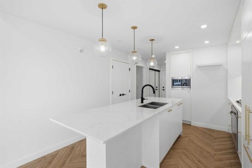 307-8445 Broadcast Avenue Sw, Calgary, AB - Indoor Photo Showing Kitchen With Double Sink With Upgraded Kitchen