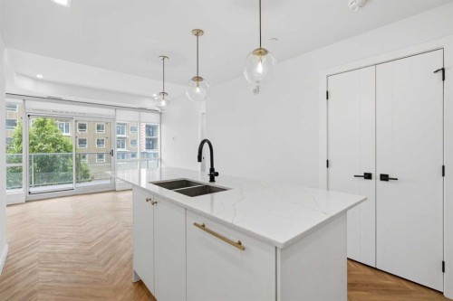 307-8445 Broadcast Avenue Sw, Calgary, AB - Indoor Photo Showing Kitchen With Double Sink With Upgraded Kitchen