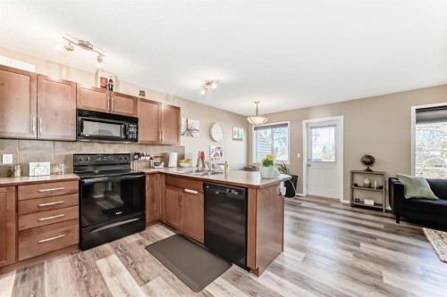 602-800 Yankee Valley Boulevard Se, Airdrie, AB - Indoor Photo Showing Kitchen With Double Sink