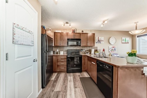 602-800 Yankee Valley Boulevard Se, Airdrie, AB - Indoor Photo Showing Kitchen With Double Sink