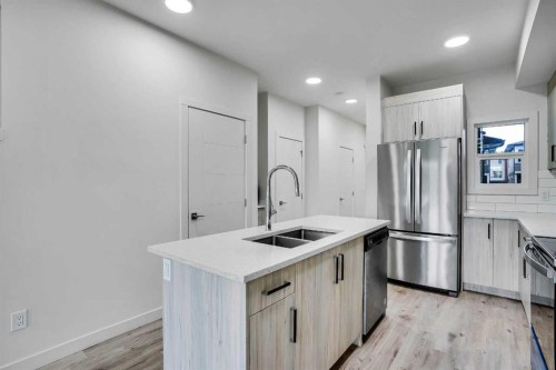 106-116 Saddlestone Heath Ne, Calgary, AB - Indoor Photo Showing Kitchen With Stainless Steel Kitchen With Double Sink With Upgraded Kitchen