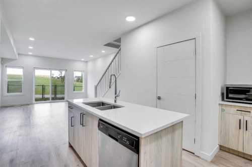 106-116 Saddlestone Heath Ne, Calgary, AB - Indoor Photo Showing Kitchen With Double Sink
