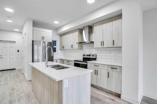 106-116 Saddlestone Heath Ne, Calgary, AB - Indoor Photo Showing Kitchen With Stainless Steel Kitchen With Double Sink With Upgraded Kitchen