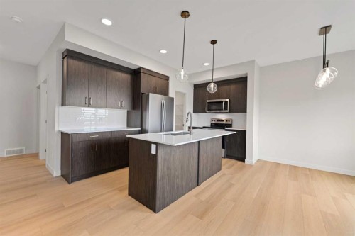 38 Waterford Mews, Chestermere, AB - Indoor Photo Showing Kitchen With Upgraded Kitchen