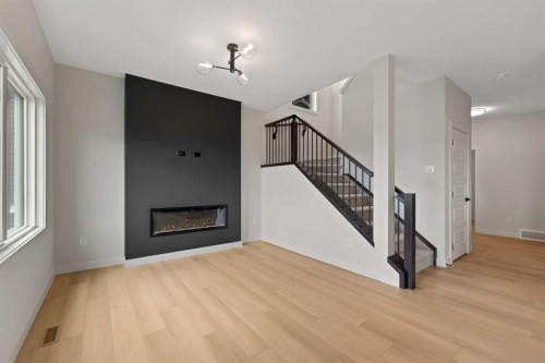 38 Waterford Mews, Chestermere, AB - Indoor Photo Showing Living Room With Fireplace
