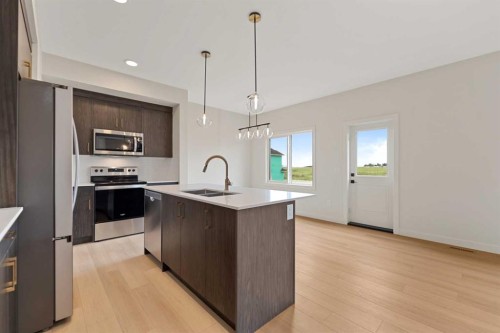38 Waterford Mews, Chestermere, AB - Indoor Photo Showing Kitchen With Double Sink With Upgraded Kitchen