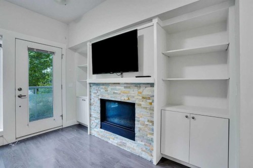 207-20 Brentwood Common Nw, Calgary, AB - Indoor With Fireplace