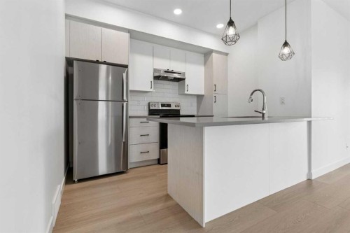 1001-24 Rivercrest Drive, Cochrane, AB - Indoor Photo Showing Kitchen With Stainless Steel Kitchen With Upgraded Kitchen