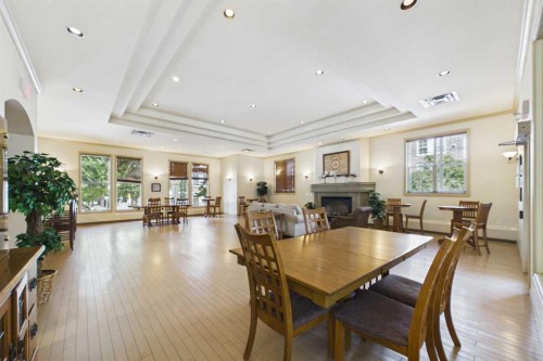 254-3000 Marda Link Sw, Calgary, AB - Indoor Photo Showing Dining Room With Fireplace