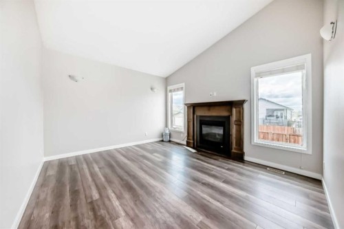 110 Cedar Square, Blackfalds, AB - Indoor Photo Showing Living Room With Fireplace