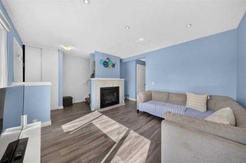 538 Woodbine Boulevard Sw, Calgary, AB - Indoor Photo Showing Living Room With Fireplace