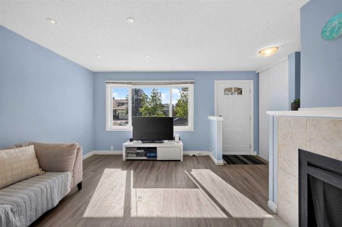 538 Woodbine Boulevard Sw, Calgary, AB - Indoor Photo Showing Living Room With Fireplace
