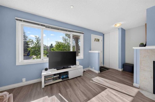 538 Woodbine Boulevard Sw, Calgary, AB - Indoor Photo Showing Living Room With Fireplace
