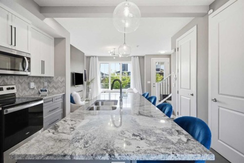 332 Lawthorn Way Se, Airdrie, AB - Indoor Photo Showing Kitchen With Double Sink With Upgraded Kitchen